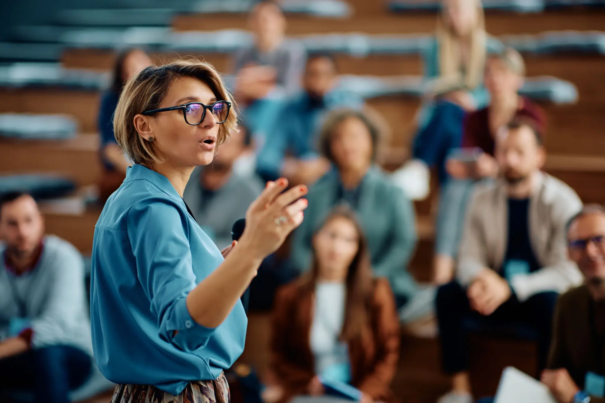 Female lecturer speaking to attentive students